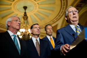 Senate Majority Leader Mitch McConnell of Ky., right, accompanied by, from left, Sen. Roger Wicker, R-Miss., Sen. John Barrasso, R-Wyo. and Sen. John Thune, R-S.D., speaks to the media during a news conference on Capitol Hill in Washington, Tuesday, June 2, 2015, following a Senate policy luncheon as legislation to end the National Security Agency's collection of Americans' calling records while preserving other surveillance authorities is expected to clear the Senate late Tuesday. But House leaders have warned their Senate counterparts not to proceed with planned changes to a House version. (AP Photo/Andrew Harnik)