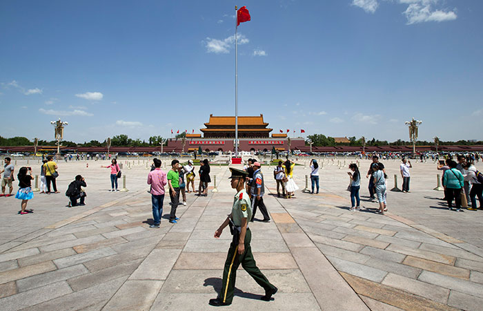 A paramilitary policeman patrols Tiananmen Square in Beijing, China, on Tuesday. (Alexander F. Yuan/The Associated Press)