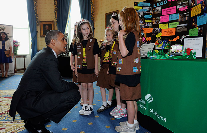 President Barack Obama talks with a group of girl scouts from Tulsa, Okla., who designed a  "flood-proof" bridge as he tours the 2014 White House Science Fair exhibits that are on display in the State Dining Room of the White House in Washington, Tuesday, May 27, 2014. Obama was celebrating the student winners of a broad range of science, technology, engineering and math (STEM) competitions from across the country. (AP Photo/Susan Walsh)