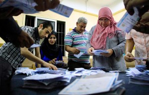 Election workers count ballots at a center in Cairo on Wednesday, May 28. With nearly all votes counted, Egypt's former military chief Abdel-Fattah el-Sissi won over his opponent with more than 92 percent of the votes, according to results announced by his campaign. The campaign said he won 23.38 million votes, with left-wing politician Hamdeen Sabahi taking 735,285. (Lobna Tarek, El Shorouk Newspaper/Associated Press)