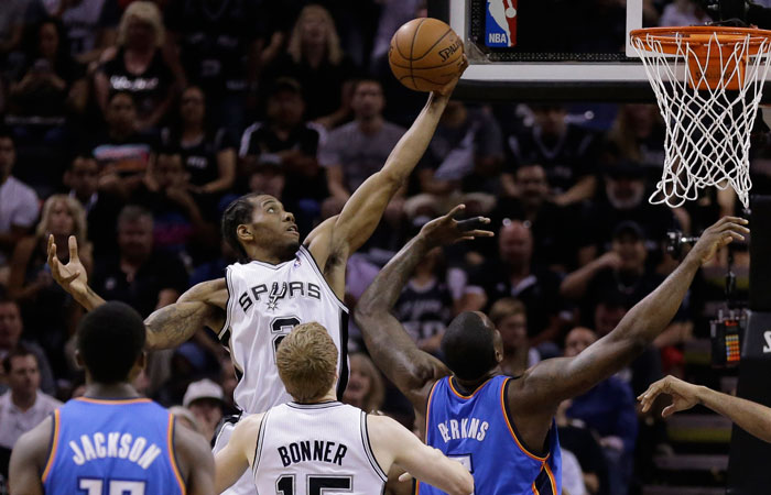 San Antonio Spurs' Kawhi Leonard grabs a defensive rebound against the Oklahoma City Thunder during the first half of Game 5 of the Western Conference finals NBA basketball playoff series, Thursday, May 29, 2014, in San Antonio. (AP Photo/Eric Gay)