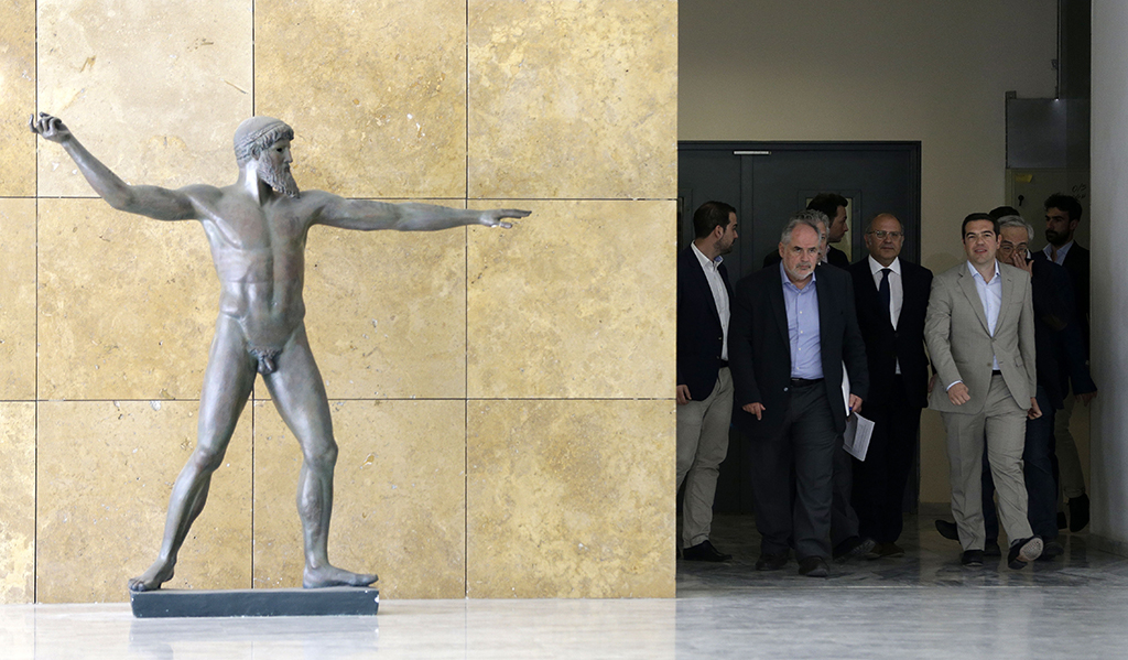 Greece's Prime Minister Alexis Tsipras, right, is accompanied by officials during his visit at the Education Ministry in Athens, Tuesday, June 2, 2015. Tsipras says Greece has submitted a proposal for an agreement with its creditors, as Athens seeks a deal that will to unlock desperately needed rescue money. (AP Photo/Thanassis Stavrakis)