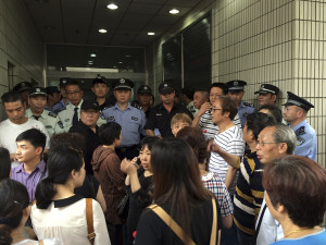 Relatives of Shanghai passengers on board a cruise ship that capsized in central China, attempt to storm a government office to demand for action after the tourist agency which organized the tour failed to help them, in Shanghai, China, Tuesday, June 2, 2015. Such quick outrage mirrors the responses of victims' relatives from other recent disasters such as last year’s disappearance of Malaysian Airlines Flight 370, which carried hundreds of Chinese travelers when it vanished from radars. (AP Photo)