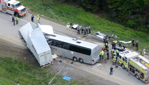 Authorities investigate the scene of a fatal collision between a tractor-trailer and a tour bus on Interstate 380 near Mount Pocono, Pa., Wednesday, June 3, 2015. Multiple people were killed and more than a dozen were sent to hospitals. (AP Photo/David Kidwell)